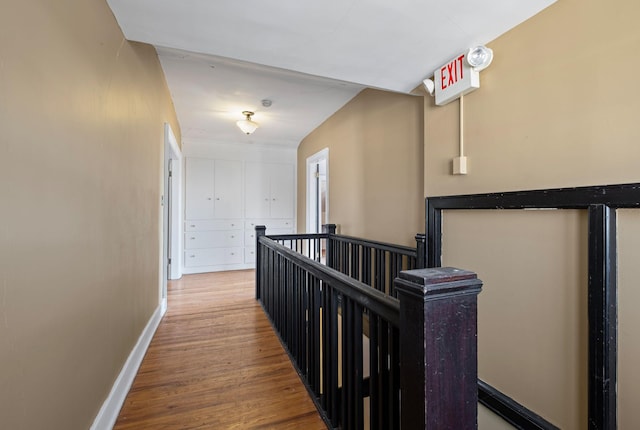 corridor with hardwood / wood-style floors