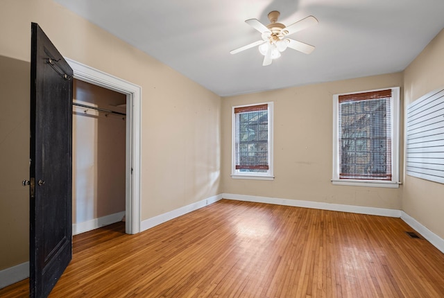 unfurnished bedroom with ceiling fan, a closet, and light hardwood / wood-style floors