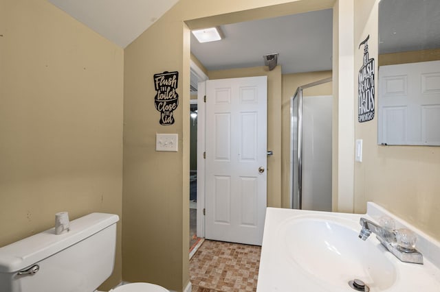 bathroom featuring toilet, lofted ceiling, an enclosed shower, and vanity