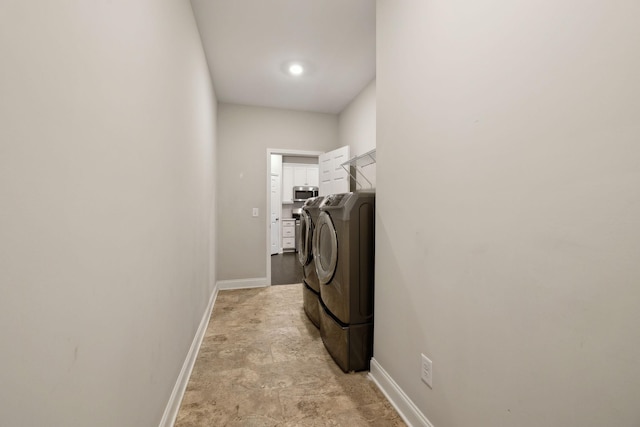 clothes washing area with washer and clothes dryer