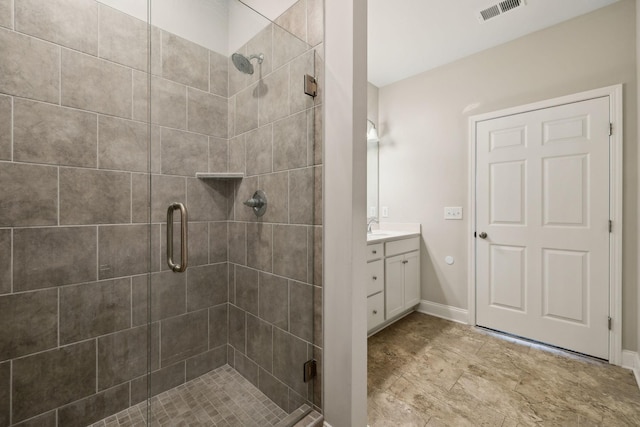 bathroom featuring vanity and a shower with door