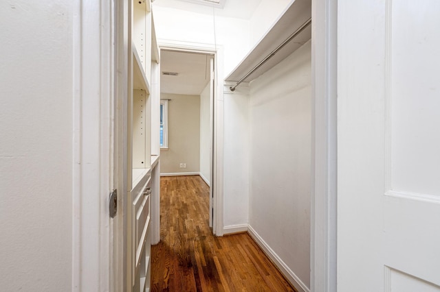 spacious closet featuring dark hardwood / wood-style floors