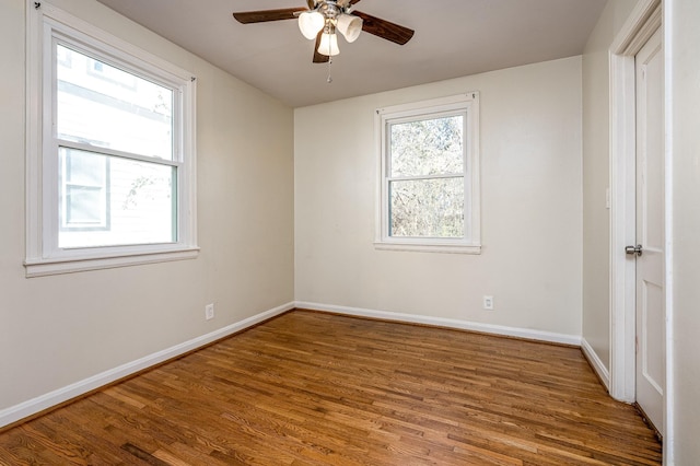 empty room featuring ceiling fan and hardwood / wood-style floors