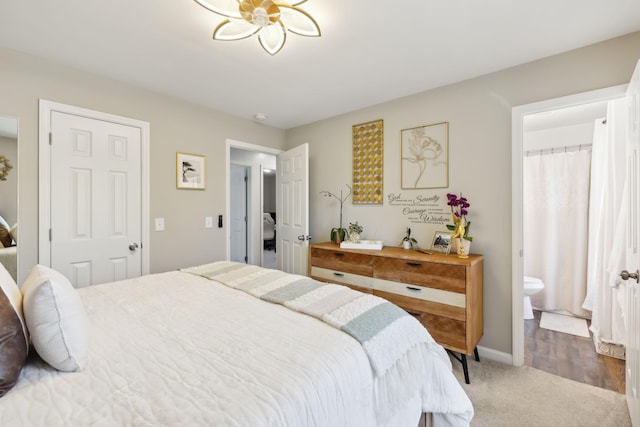 carpeted bedroom featuring ensuite bathroom