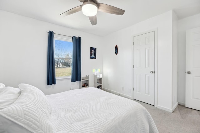 bedroom with ceiling fan and light carpet