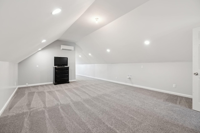 additional living space featuring light colored carpet, an AC wall unit, and vaulted ceiling