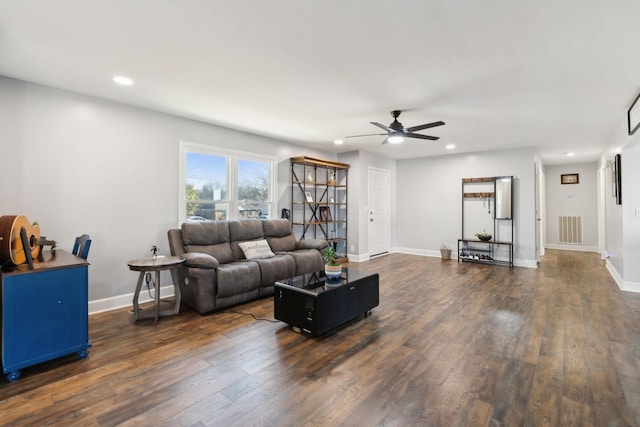 living room featuring ceiling fan and dark hardwood / wood-style floors