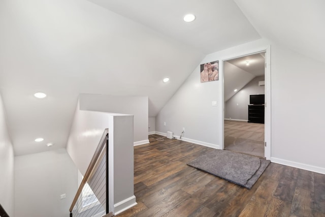 additional living space with dark hardwood / wood-style floors and vaulted ceiling