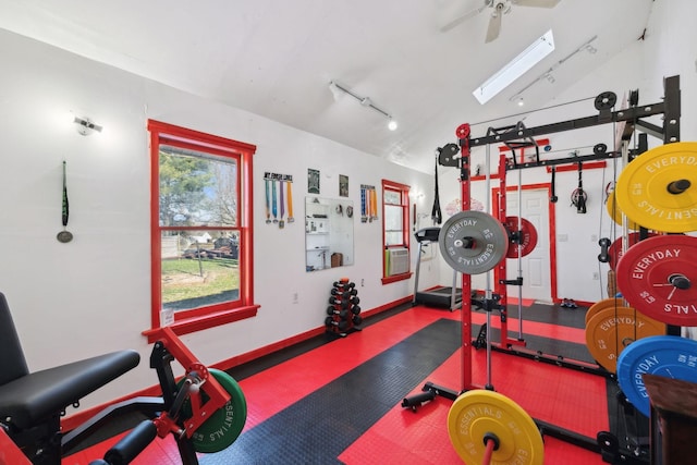 exercise room with ceiling fan and lofted ceiling