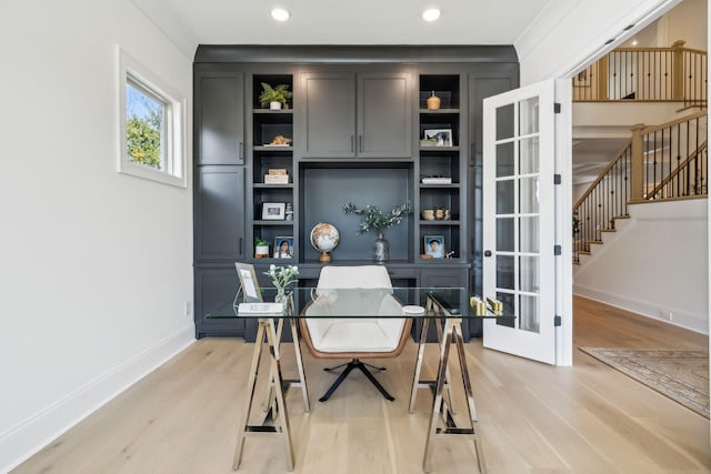 office featuring built in shelves, ornamental molding, light hardwood / wood-style flooring, and french doors