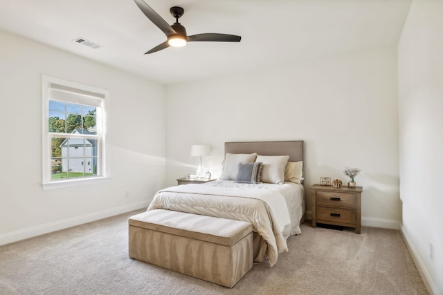 bedroom featuring ceiling fan and light carpet