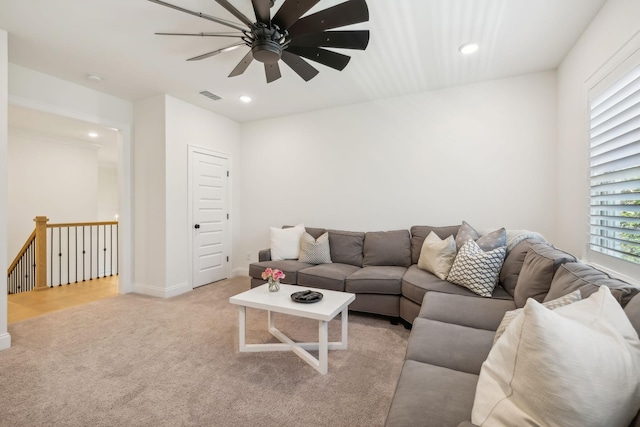 living room with light carpet and ceiling fan