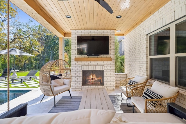 view of patio with an outdoor living space with a fireplace