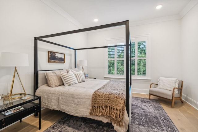 bedroom featuring wood-type flooring and ornamental molding