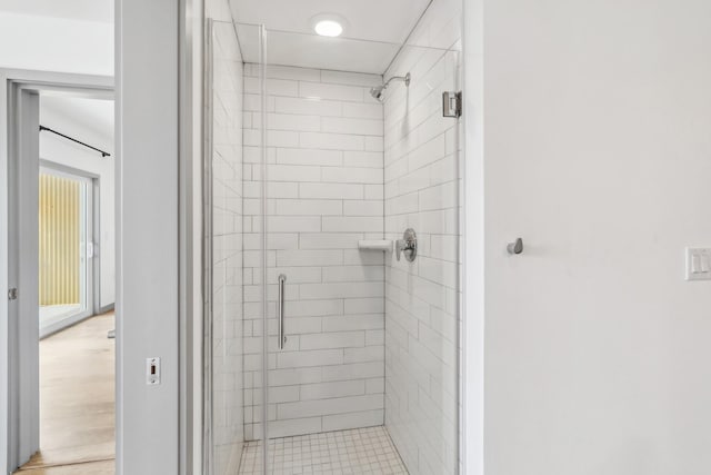 bathroom featuring a shower with shower door