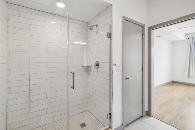 bathroom featuring a shower with door and tile patterned flooring