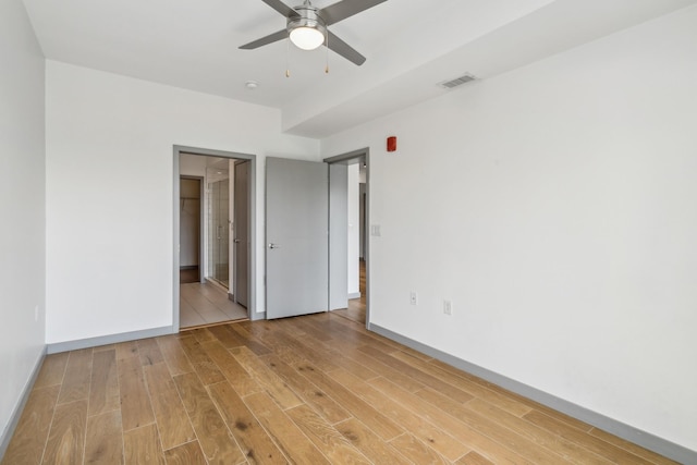 unfurnished bedroom featuring light wood-type flooring and ceiling fan