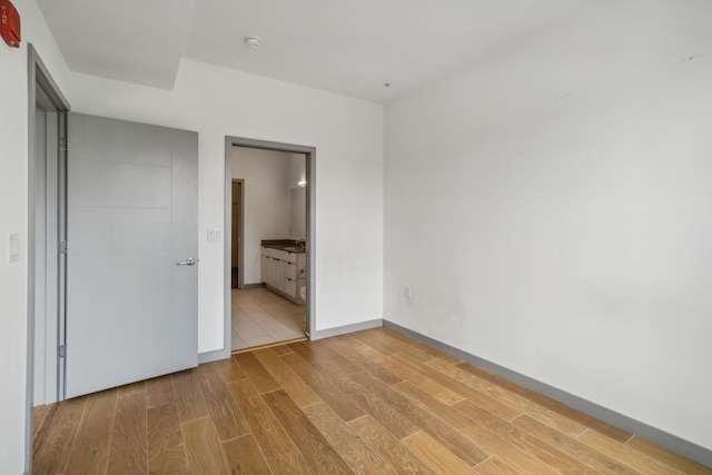 unfurnished bedroom featuring ensuite bath