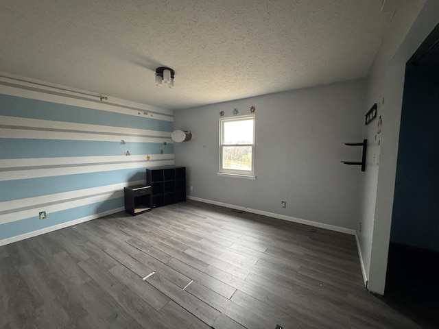 unfurnished bedroom featuring a textured ceiling and wood-type flooring