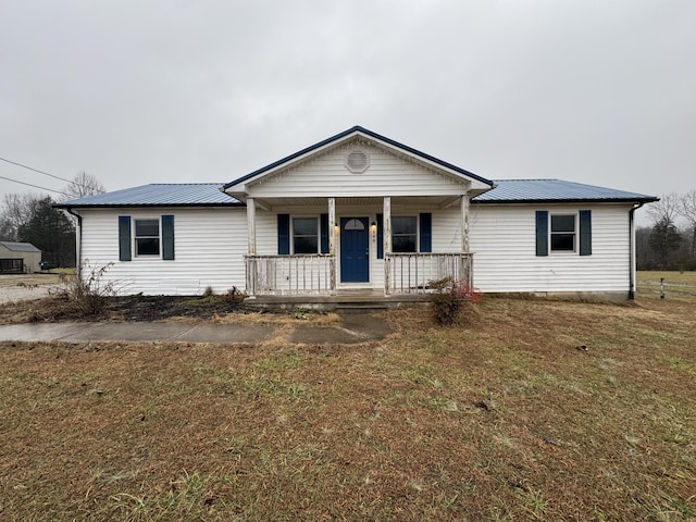 ranch-style home with a porch and a front yard