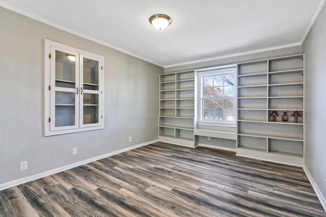 empty room with dark hardwood / wood-style flooring and crown molding