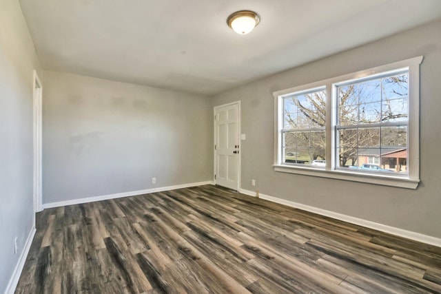 unfurnished room featuring dark hardwood / wood-style flooring