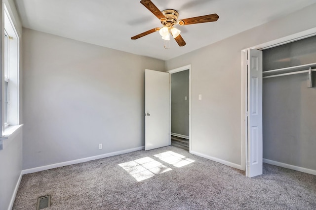 unfurnished bedroom with ceiling fan, light colored carpet, and a closet