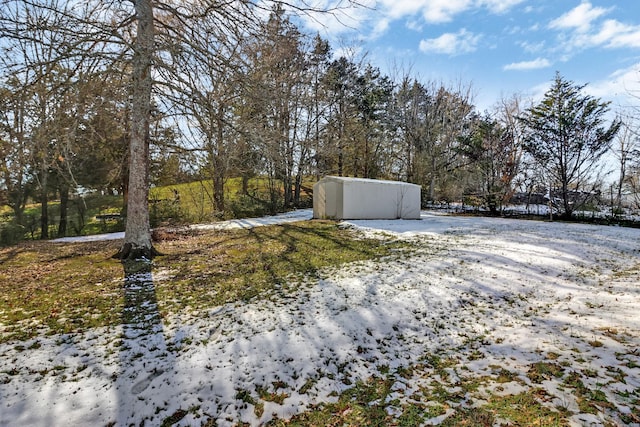 yard layered in snow with an outdoor structure