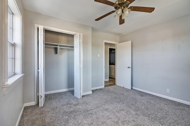 unfurnished bedroom with ceiling fan, multiple windows, a closet, and light carpet