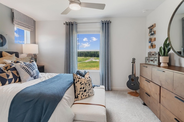 bedroom featuring light carpet and ceiling fan