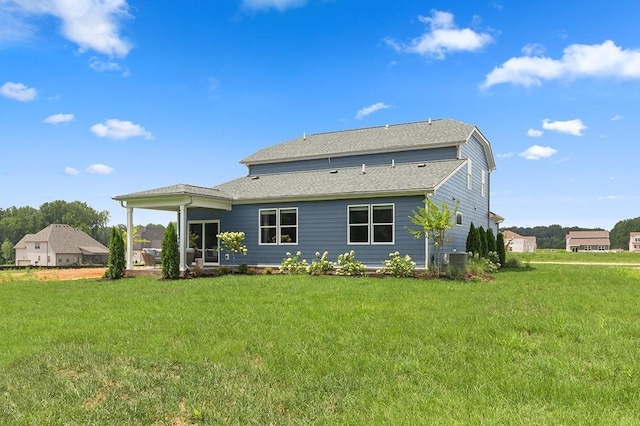 back of house featuring a yard