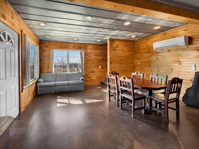 dining room featuring a wall unit AC and wooden walls