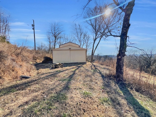 view of yard with a rural view and an outdoor structure