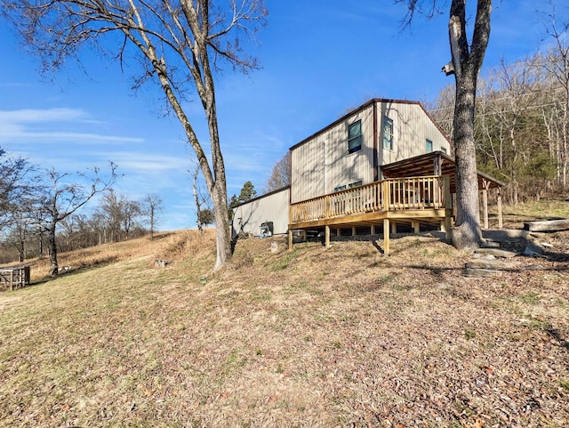 back of house with a deck