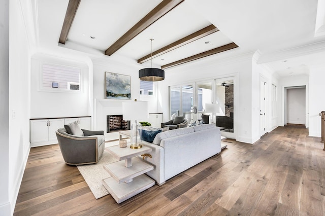 living room featuring ceiling fan, beam ceiling, and hardwood / wood-style floors