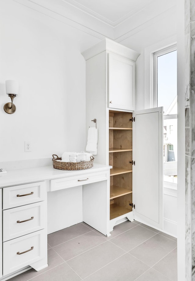 bathroom featuring tile patterned flooring and ornamental molding