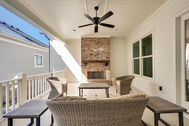 view of patio / terrace featuring ceiling fan and an outdoor living space with a fireplace