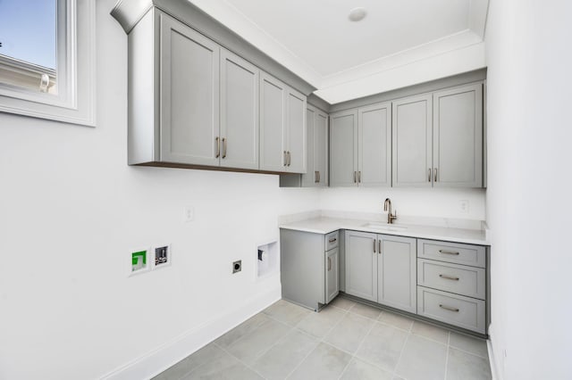 laundry room featuring cabinets, electric dryer hookup, sink, ornamental molding, and hookup for a washing machine