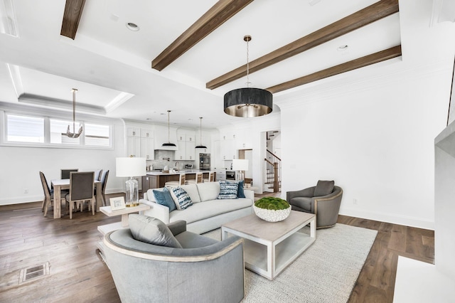 living room featuring a raised ceiling and dark hardwood / wood-style floors