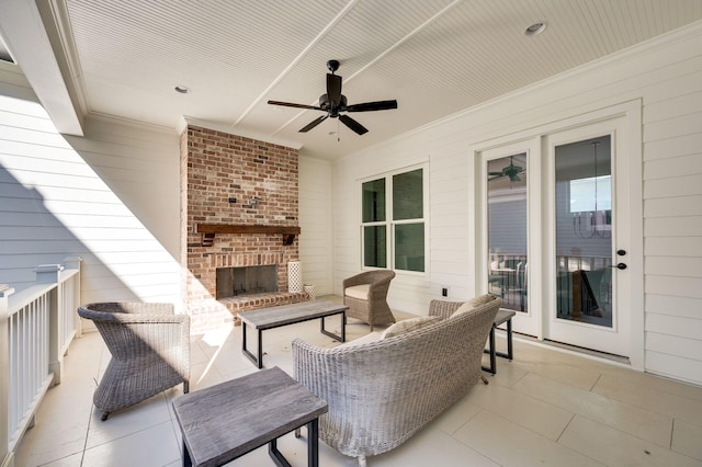 view of patio featuring an outdoor brick fireplace and ceiling fan