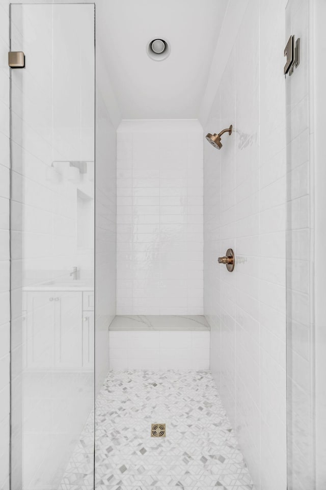 bathroom with tiled shower