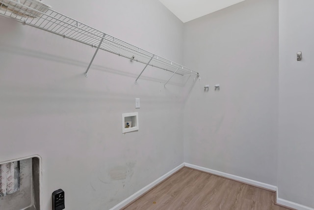 clothes washing area featuring hookup for a washing machine and wood-type flooring