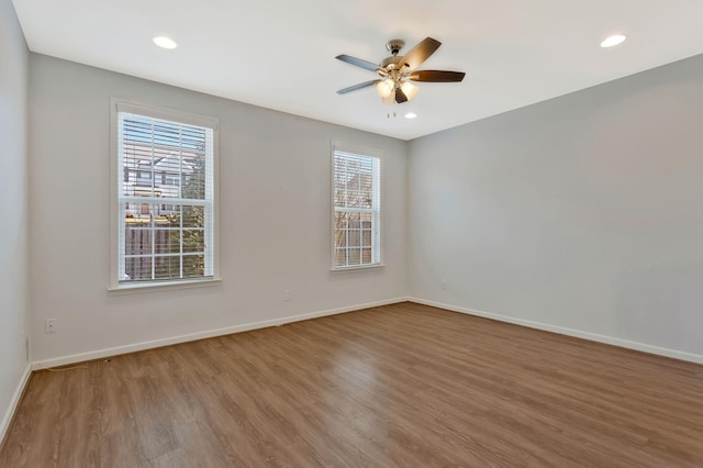 empty room with ceiling fan and hardwood / wood-style floors