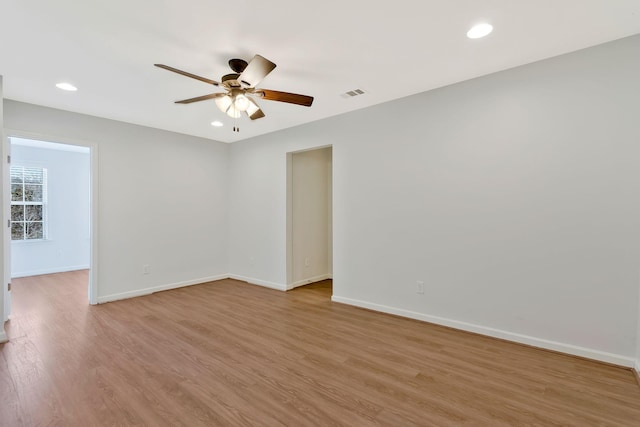 empty room with ceiling fan and light wood-type flooring