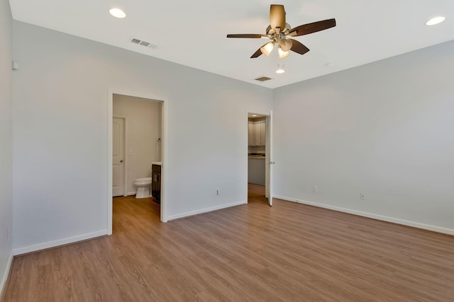 unfurnished bedroom featuring ceiling fan, connected bathroom, and light hardwood / wood-style floors