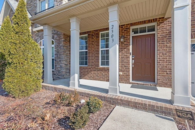 view of exterior entry with a porch