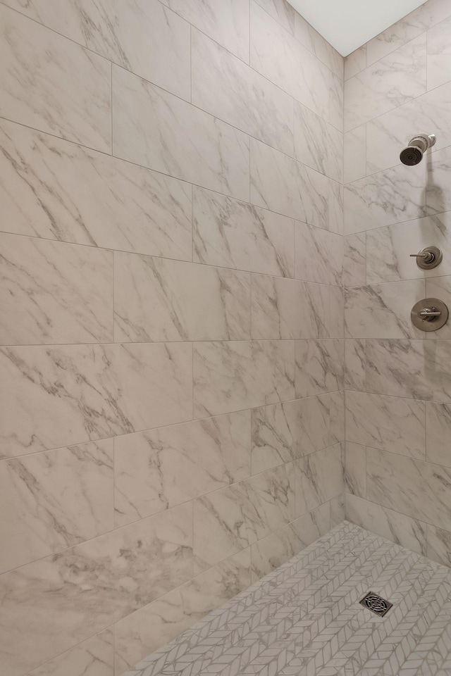 bathroom with tiled shower