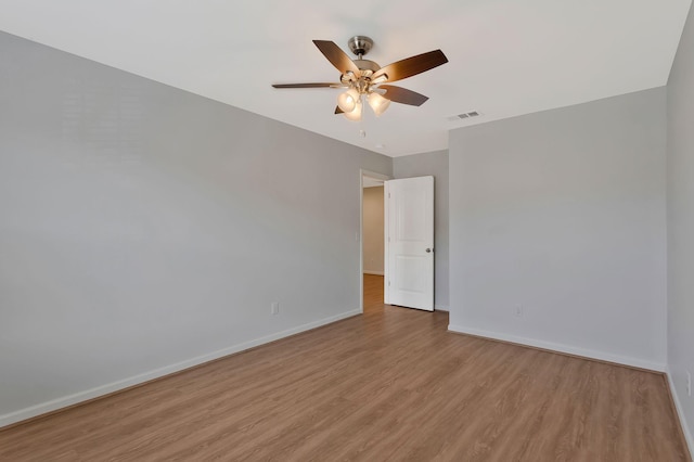 unfurnished room with ceiling fan and light wood-type flooring