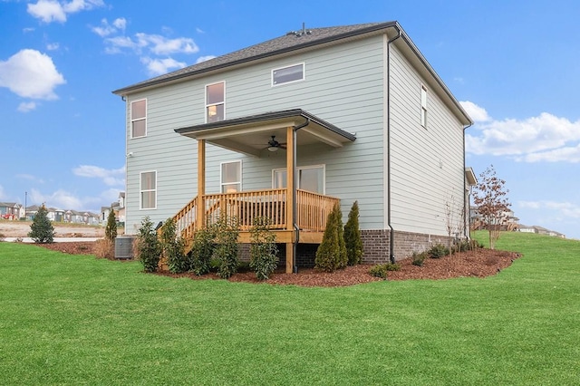 back of property with ceiling fan, a wooden deck, cooling unit, and a yard