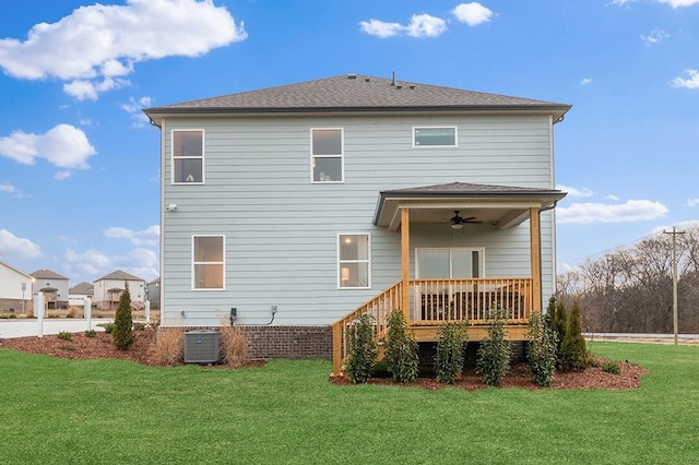 rear view of property with ceiling fan, central AC, a lawn, and a wooden deck